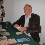 Man at table with CDs