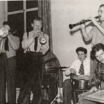 Six men playing jazz.